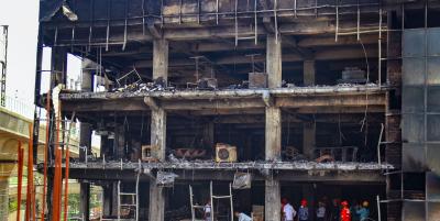 Officials investigate the Mundka fire, in New Delhi, Sunday, May 15, 2022. Twenty-seven people have died so far in the Mundka fire. Photo: PTI