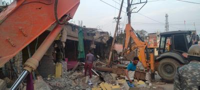 Properties being demolished after the violence. Photo: Kashif Kakvi