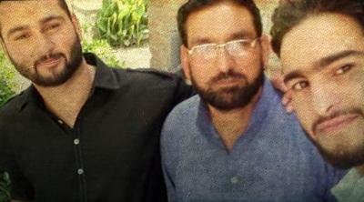 Mushtaq Ahmad Lone (Centre) with his sons Aqib (R) and Asif. Photo: By arrangement