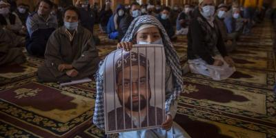 A devotee holding a photograph of Kashmir's chief cleric Mirwaiz Umar Farooq inside the grand mosque in old city Srinagar on March 5, 2021. Mirwaiz has been under continuous house detention for more than three years now. Photo: By arrangement.
