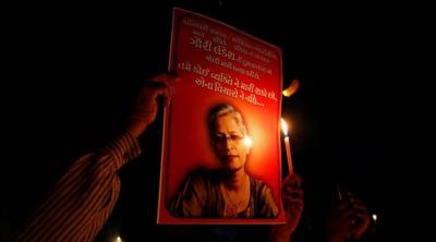 People hold placards and candles during a vigil for Gauri Lankesh, a senior Indian journalist who according to police was shot dead outside her home on Tuesday by unidentified assailants in southern city of Bengaluru, in Ahmedabad, India, September 6, 2017. REUTERS/Amit Dave