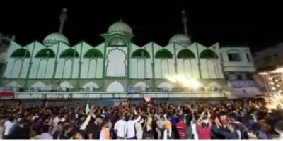 Video screencrab showing members of a procession dancing to a song which allegedly had lyrics threatening violence, outside a mosque, in Karnataka's Gulbarga. 