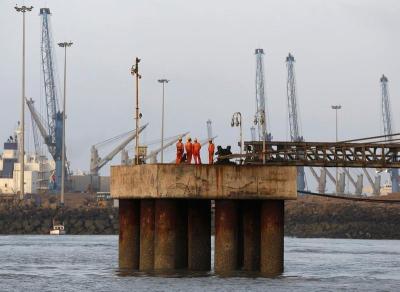 Workers wait for a cargo ship to beach at Mundra Port in Gujarat April 2, 2014. The rising volume in drug trafficking implies that our coasts remain vulnerable to the possibility of narco-terrorism attacks. Credit: Reuters/Amit Dave