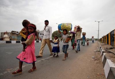 Migrant workers walk with their children to their villages after India announced a nationwide lockdown due to the coronavirus pandemic. Photo: Reuters