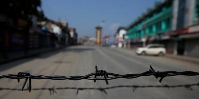 Barbed wire is seen laid on a deserted road during restrictions in Srinagar, August 5, 2019. Photo: Reuters/Danish Ismail