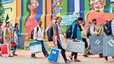 Representational image. Polling officials, after collecting electronic voting machines (EVMs)and other election material, move to their respective polling station on the eve of Karnataka assembly elections in Bengaluru in May 2018. Credit: PTI