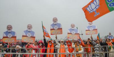 BJP supporters hold posters of Prime Minister Narendra Modi as they wait at the venue of PMs rally after it was canceled, amid rain in Ferozepur, Wednesday, Jan. 5, 2022. Photo: PTI
