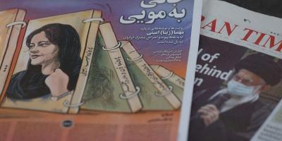 A newspaper with a cover picture of Mahsa Amini, a woman who died after being arrested by the Islamic republic's 