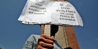 A demonstrator displays a placard during a protest against minorities killings in Kashmir, in Srinagar June 2, 2022. Photo: Reuters/Danish Ismail

