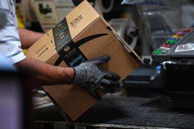 Representative image of a worker handling an Amazon package in the US. Photo: Reuters