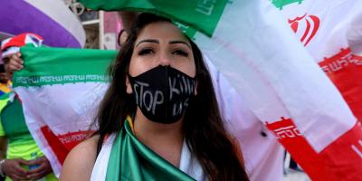 FILE PHOTO: Soccer Football - FIFA World Cup Qatar 2022 - Group B - Wales v Iran - Ahmad Bin Ali Stadium, Al Rayyan, Qatar - November 25, 2022. A woman wearing a mask with a message reading 'stop killing us' after the match. Photo: Reuters/Charlotte Bruneau/File Photo