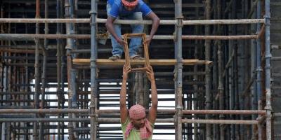Labourers work at the construction site of a residential building on the outskirts of Kolkata, India, July 5, 2019. REUTERS/Rupak De Chowdhuri/Files