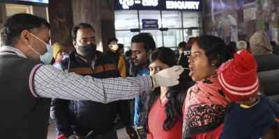 A medic collects swab sample from a passenger at a railway station, amid sudden spurt in COVID cases in some countries, in Patna, Friday, Dec. 23, 2022. Photo: PTI. 