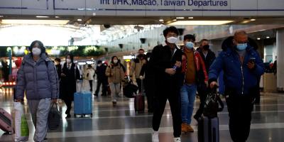 Travellers walk with their luggage at Beijing Capital International Airport, amid the coronavirus disease (COVID-19) outbreak in Beijing, China December 27, 2022. 