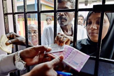 People exchanging notes by showing their IDs. Photo: PTI