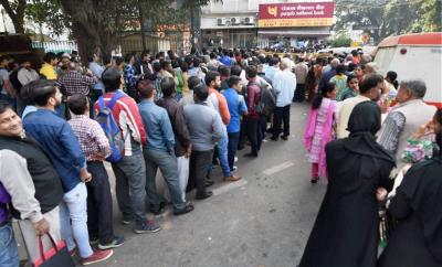 FILE IMAGE: People standing in long queues to exchange their old Rs 500 and 1000 notes and withdraw cash from the ATM in New Delhi, November 2016. Photo: PTI/Subhav Shukla/Files