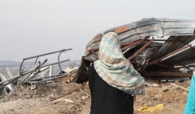 A Palestinian woman looks at her demolished house. Photo: dombook11/Flickr CC BY 2.0