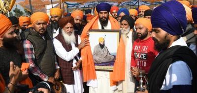 Amritpal Singh with a photo of militant leader Jarnail Singh Bhindranwale. Photo: Twitter