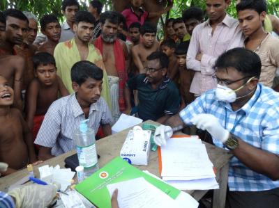 A doctor checks for tuberculosis at a health camp. Photo: cdcglobal/Flickr, CC BY 2.0