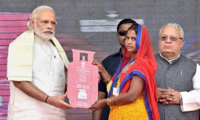Prime Minister Narendra Modi distributes the free LPG connections to the beneficiaries, under PM Ujjwala Yojana in Ballia on May 1, 2016. Union Minister for Micro, Small and Medium Enterprises Kalraj Mishra is also seen. Photo: PTI