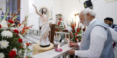 Prime Minister Narendra Modi lighting a candle at Delhi's Sacred Heart Cathedral Catholic Church on the occasion of Easter, in New Delhi on April 9, 2023. Photo: PIB
