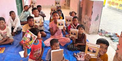 Tharu children hold their notebooks at the Ekal Study Centre in Palia Kalan. Photo: Tarushi Aswani