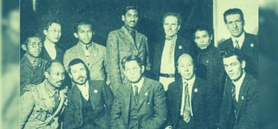 (Sitting in row) Sen Katayama (middle) is flanked by Nguyen Ai Quoc on the left, and Grigory Zinoviev on the right. (Standing in row) Tan Malaka (third from left) is flanked by M.N. Roy. 