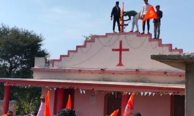 Right-wing activists plant a saffron flag atop a holy cross, in Jhabua, Madhya Pradesh, on January 21, 2024. Photo: Special arrangement 