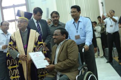 File photo of  President  Pranab Mukherjee presenting GN Saibaba with his doctoral degree at the 90th convocation of Delhi University on March 19, 2013.