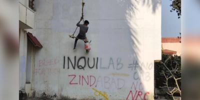 Graffiti which came up during anti-CAA protest on Jamia Milia campus in Delhi is being erased. Photo: Ismat Ara. 