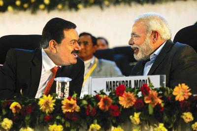 Narendra Modi and Gautam Adani at the Vibrant Gujarat summit. Credit: Twitter/Files