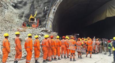 Rescuers at the mouth of the Silkyara tunnel. Photo: X/@KirenRijiju