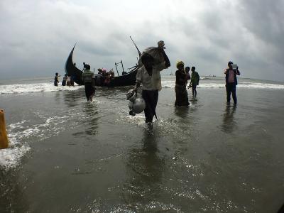 Rohingya refugees getting off boats. Photo: Flickr/Prachatai, CC BY-NC-ND 2.0 DEED