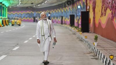 Prime Minister Narendra Modi with an empty bottle he picked up while inaugurating the Pragati Maidan Tunnel. 