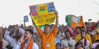 A man holds a poster reading 'Janta hai taiyar, phir se Modi sarkar (The public is ready for another Modi government)'. Photo: X/@narendramodi